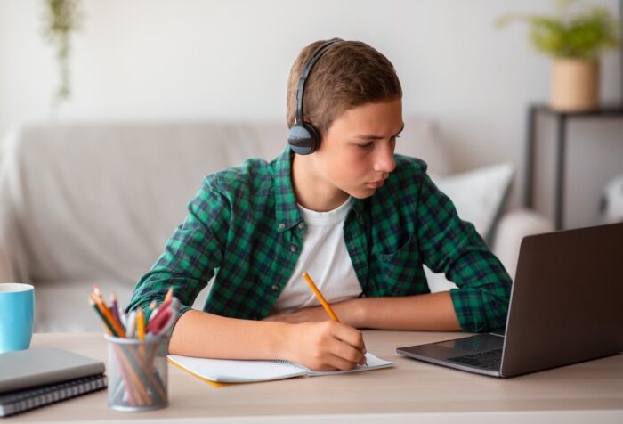 Boy studying in bedroom