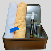 A Murphy Bed touch-up kit, including tools and materials used for repairing and maintaining furniture finishes